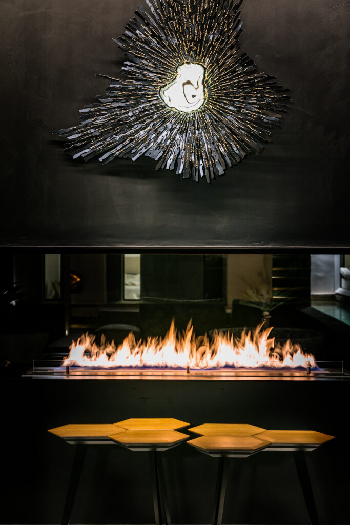 a modern fireplace in an elegant hotel