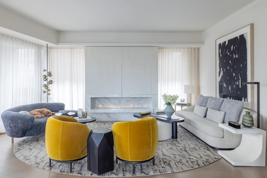 the fireplace wall beautifully complements the modern interior of the high-rise apartment